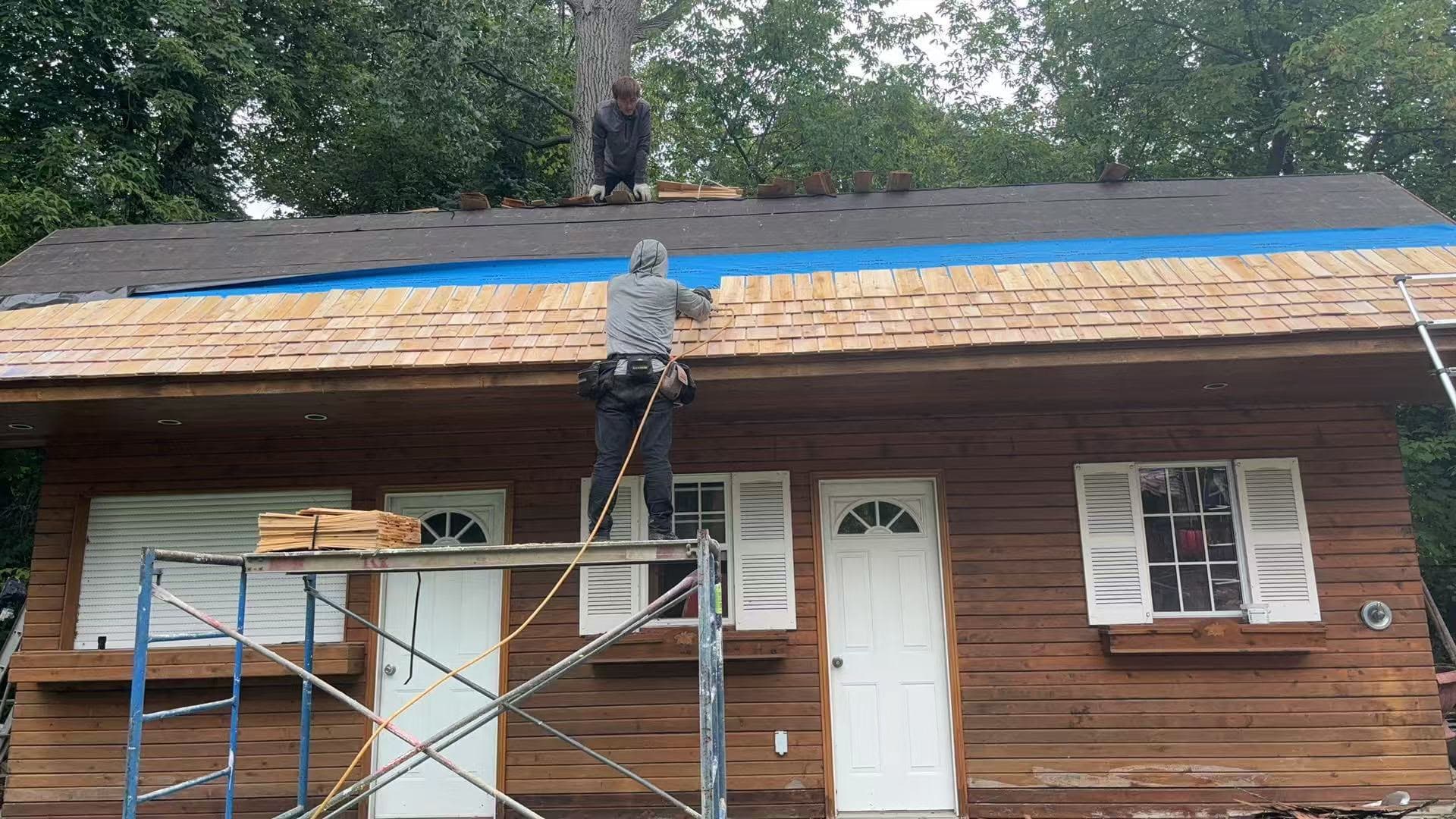 Tomato Roofing crew installing cedar shingles